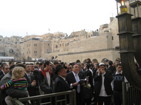 Rav Bina lighting the Chanukiah